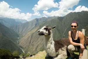 Woman and llama at Machu Pichu, Peru